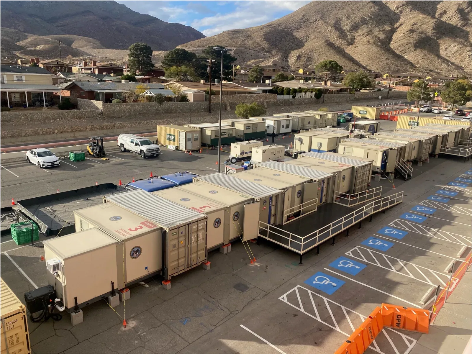 Connected C-FORTS medical facility with multiple shelters, entrance ramps and support equipment in a parking lot