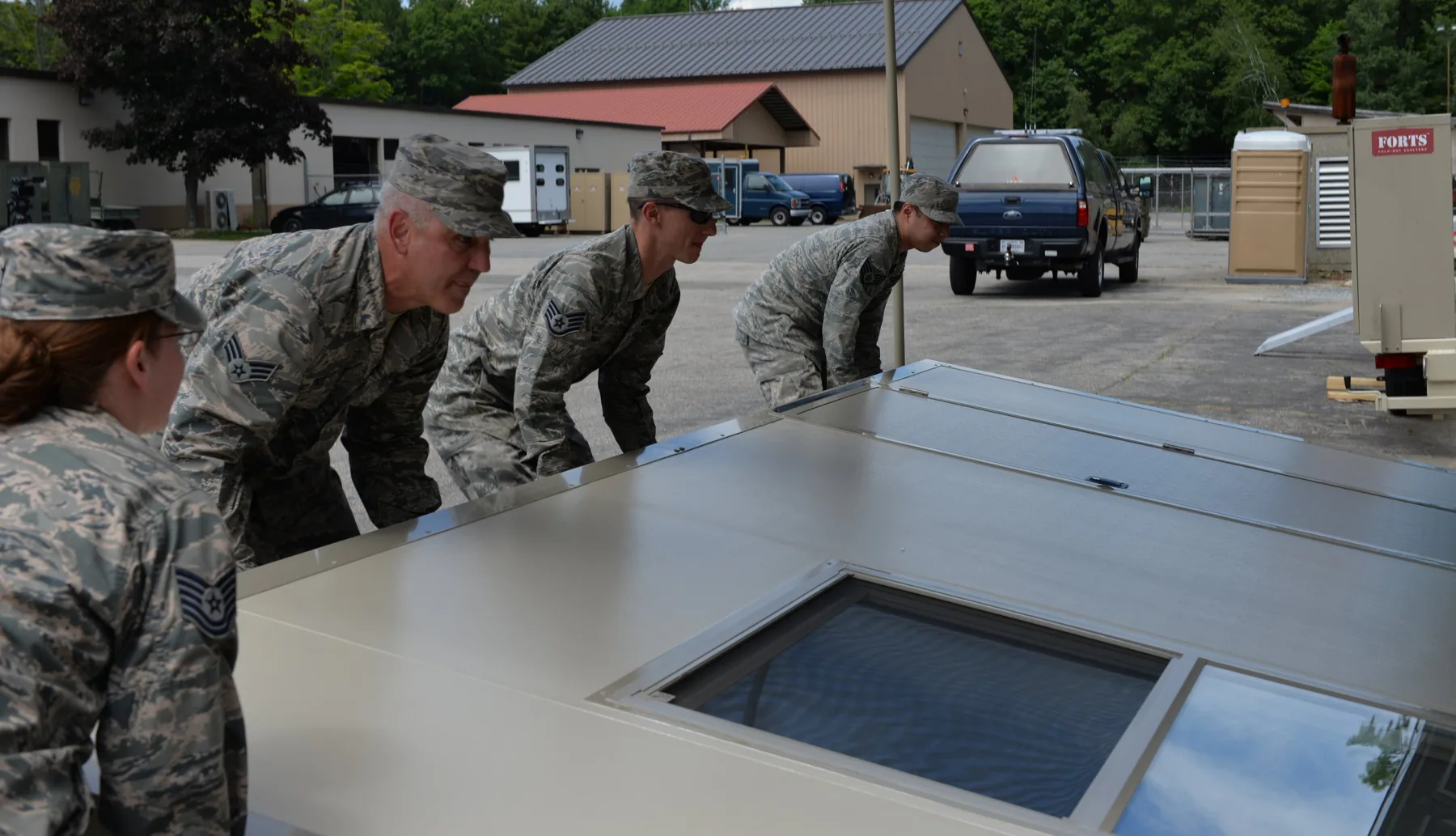 Uniformed personnel positioning a FORTS wall during setup