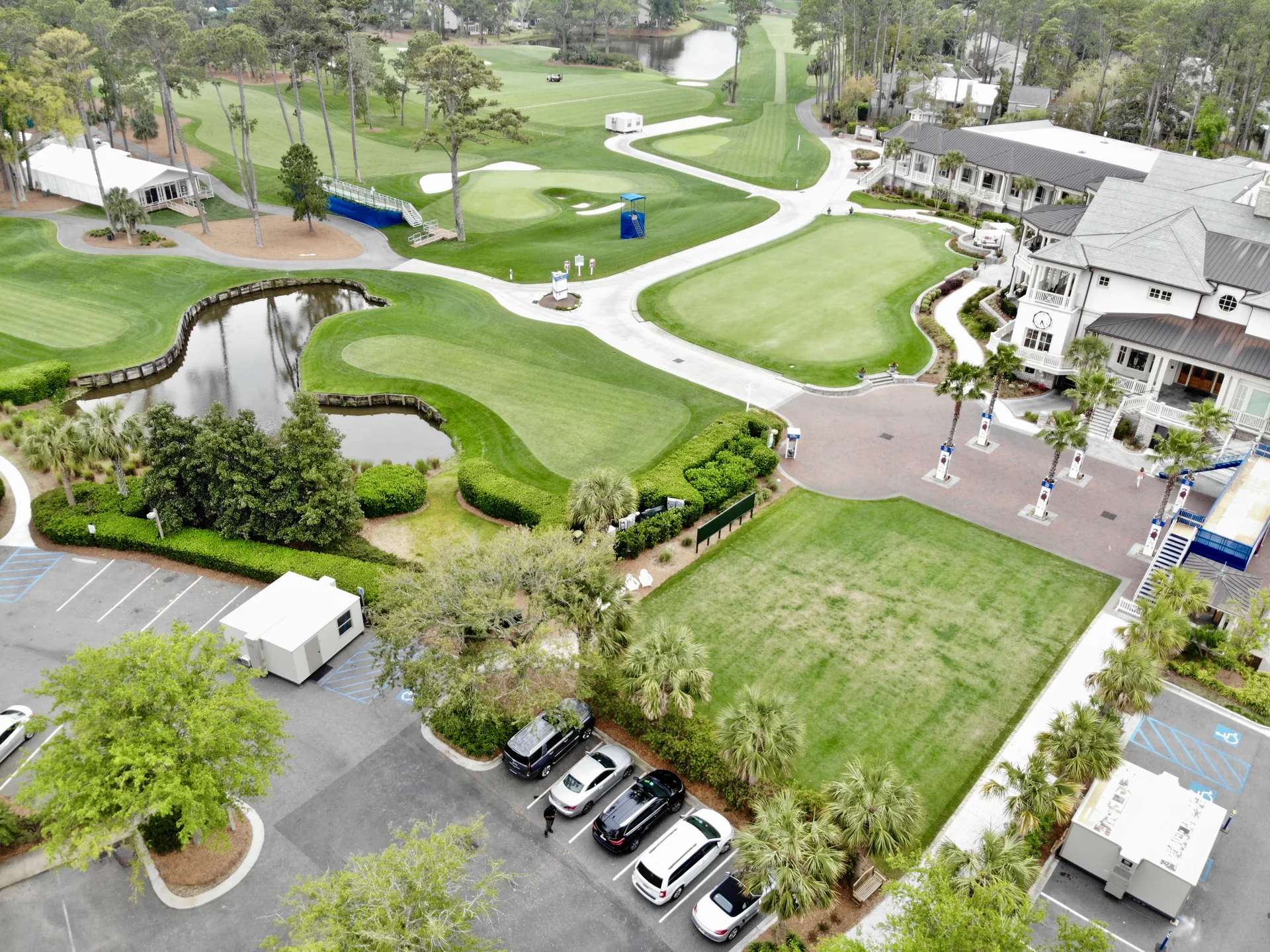 Golf putting greens, flagsticks, bunkers and clubhouse at RBC Heritage, with FORTS units beside the course.