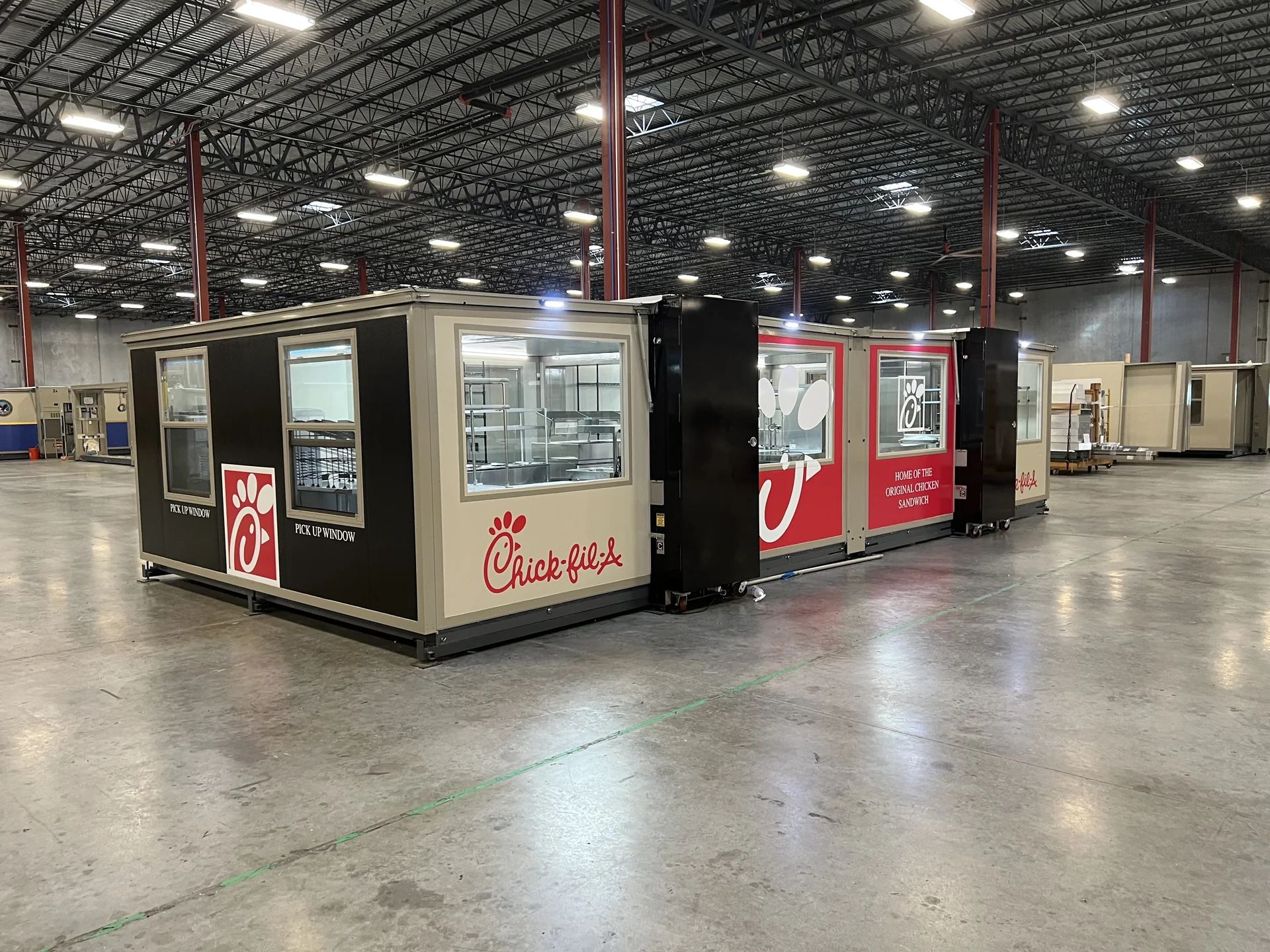 Connected FORTS units with Chick-fil-A branding, pickup windows and interior service equipment.