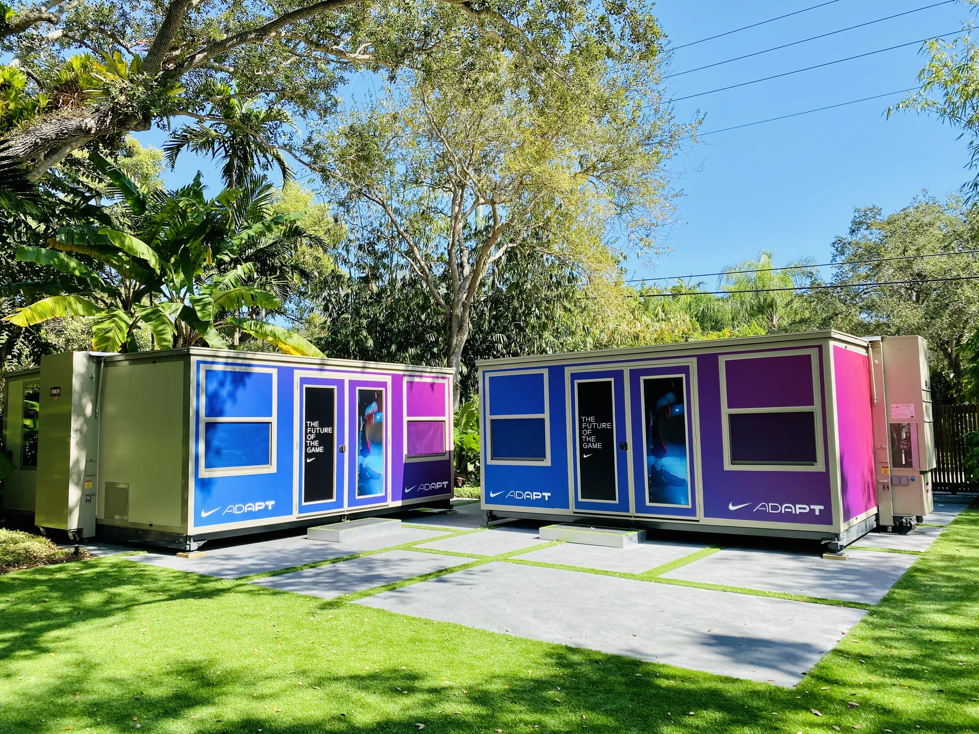 NIKE Adapt-branded FORTS units with purple and blue exterior graphics in a landscaped setting.